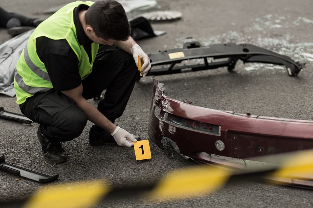 Photo of policeman working at scene after Wrongful Death in fatal car collision