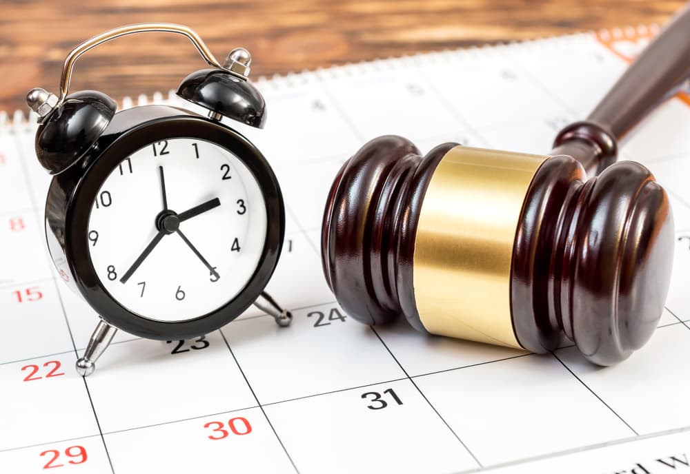 A Judge's gavel with clock and calendar