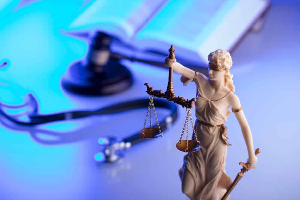 Gavel, stethoscope, blue light. Seeking compensation in wrongful death